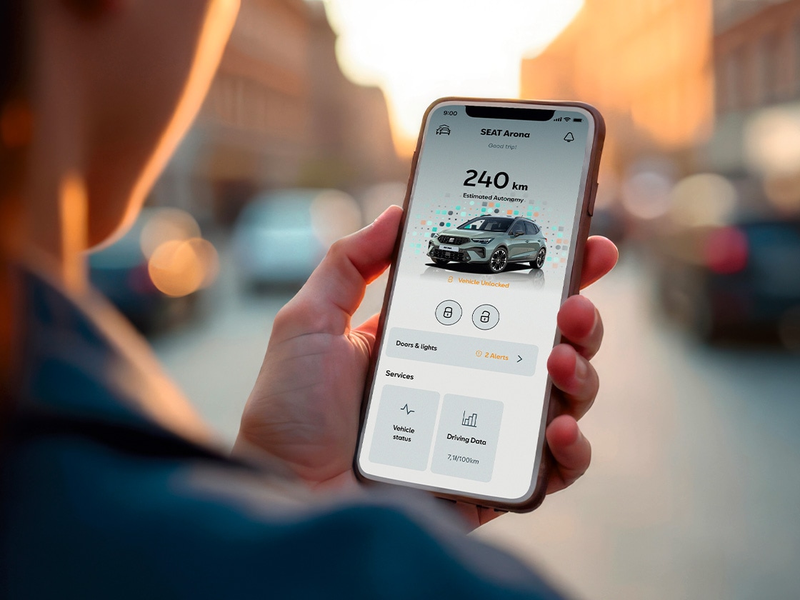 Person holding their smartphone using my SEAT app