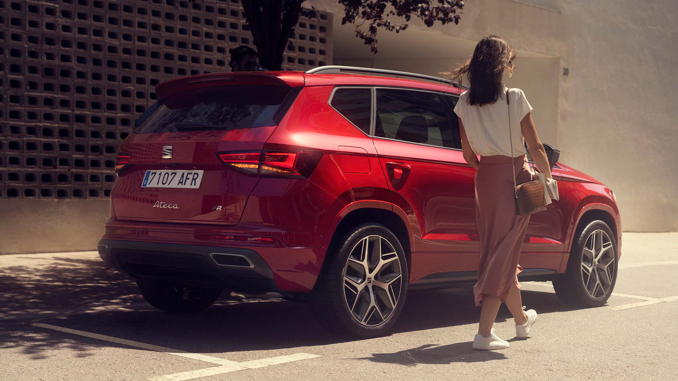 -walking-next-to-seat-ateca-velvet-red-colour